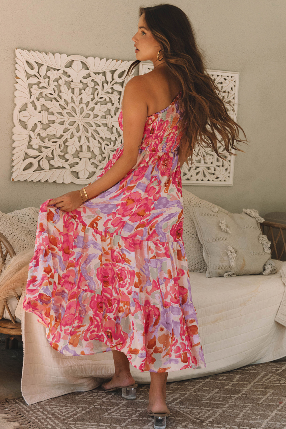 Back view of Sunset Bloom one-shoulder dress and flowing floral skirt